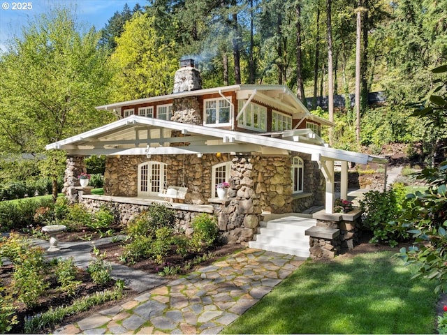49 Briarwood Rd, Lake Oswego, OR 97034 - back of house featuring stone siding, a chimney, french doors, and a porch