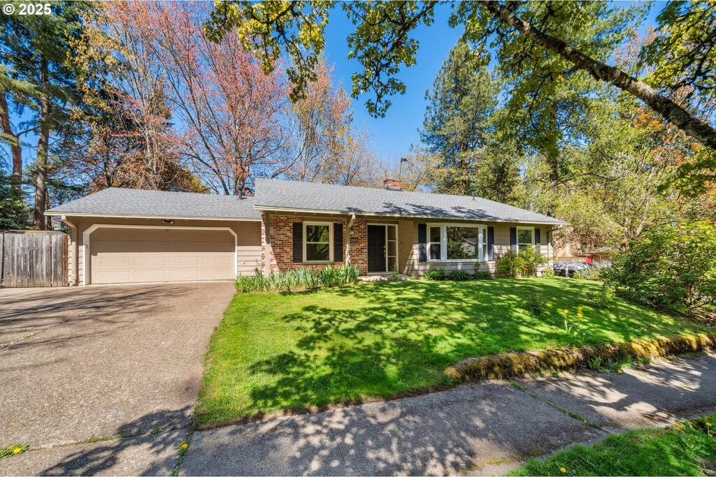 14265 SW Stallion Dr, Beaverton, OR 97008 - ranch-style home with a chimney, fence, driveway, a front yard, and a garage