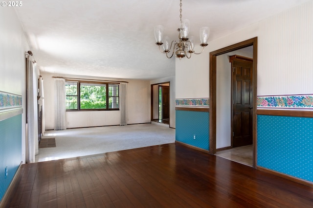8758 Thurston Rd, Springfield, OR 97478 - spare room with wallpapered walls, hardwood / wood-style flooring, and a chandelier