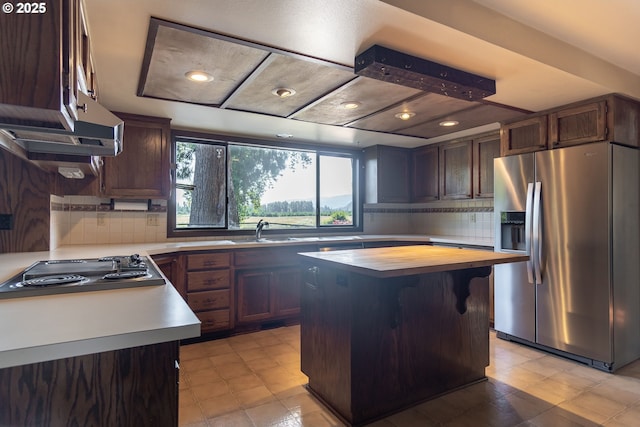 8758 Thurston Rd, Springfield, OR 97478 - kitchen featuring stainless steel fridge with ice dispenser, stovetop, backsplash, and a kitchen island