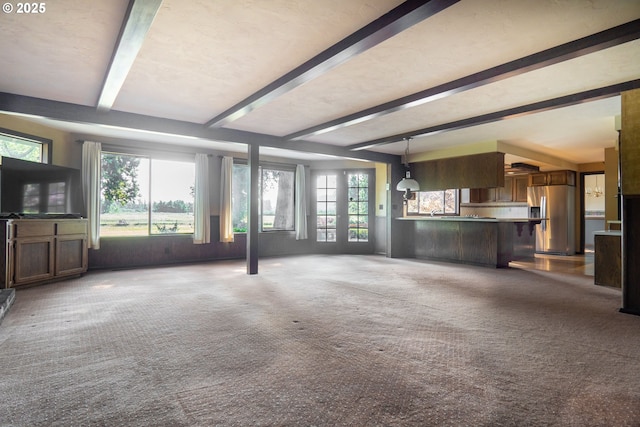 8758 Thurston Rd, Springfield, OR 97478 - unfurnished living room featuring beam ceiling and carpet