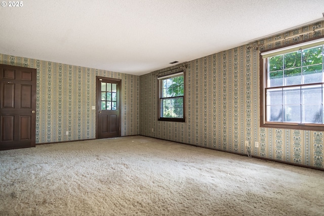 8758 Thurston Rd, Springfield, OR 97478 - carpeted spare room with a textured ceiling and wallpapered walls