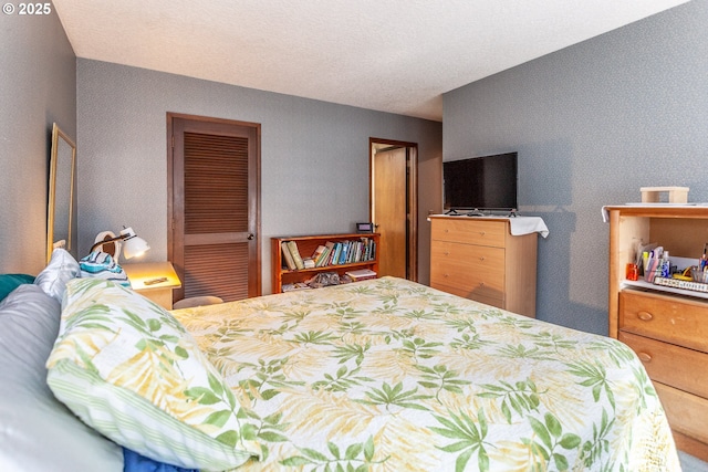 bedroom with wallpapered walls