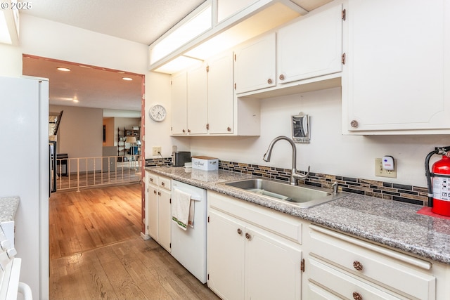 12618 NE Prescott Dr, Portland, OR 97230 - kitchen featuring decorative backsplash, white appliances, recessed lighting, a sink, and light wood finished floors