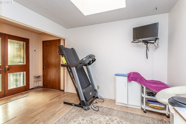 12618 NE Prescott Dr, Portland, OR 97230 - workout room with a skylight, french doors, and light wood-type flooring