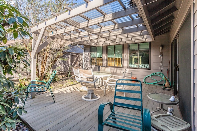 deck with outdoor dining area and a pergola