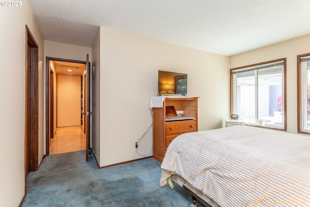 12618 NE Prescott Dr, Portland, OR 97230 - carpeted bedroom featuring baseboards and a textured ceiling