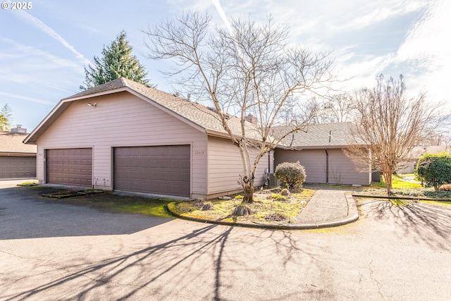 12618 NE Prescott Dr, Portland, OR 97230 - view of front of home with a detached garage and a chimney