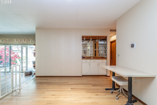 12618 NE Prescott Dr, Portland, OR 97230 - interior space with baseboards, bar, and light wood-style flooring
