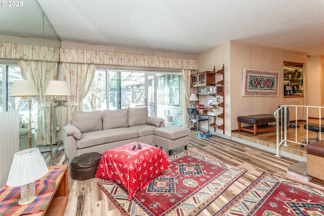 living area featuring a textured ceiling and wood finished floors