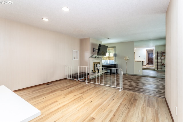 12618 NE Prescott Dr, Portland, OR 97230 - unfurnished room with baseboards, a textured ceiling, wood finished floors, and visible vents