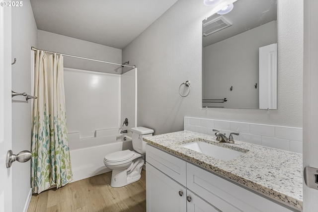 1502 Timothy St, Philomath, OR 97370 - bathroom with wood finished floors, vanity, shower / bath combination with curtain, toilet, and backsplash