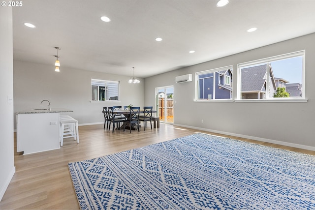 1502 Timothy St, Philomath, OR 97370 - dining space featuring a wall mounted air conditioner, baseboards, light wood-type flooring, a chandelier, and recessed lighting