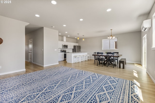 1502 Timothy St, Philomath, OR 97370 - living area with a wall mounted air conditioner, light wood-style flooring, baseboards, and recessed lighting