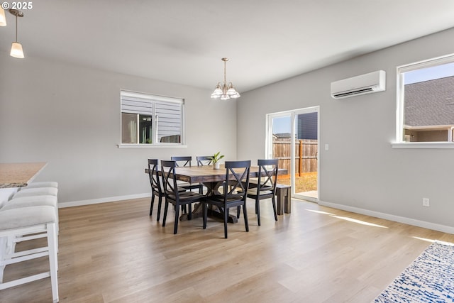 1502 Timothy St, Philomath, OR 97370 - dining area with a wall mounted air conditioner, baseboards, light wood-style floors, and a chandelier