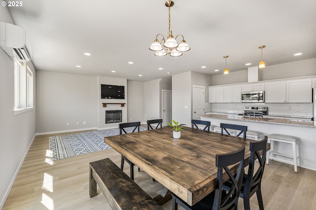 1502 Timothy St, Philomath, OR 97370 - dining room with recessed lighting, baseboards, light wood-style flooring, a chandelier, and a wall mounted AC