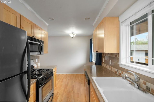 3925 SW Multnomah Blvd Unit 204, Portland, OR 97219 - kitchen featuring appliances with stainless steel finishes, a sink, light brown cabinets, decorative backsplash, and ornamental molding