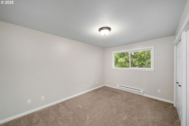 3925 SW Multnomah Blvd Unit 204, Portland, OR 97219 - unfurnished bedroom featuring baseboard heating, carpet floors, baseboards, and a textured ceiling