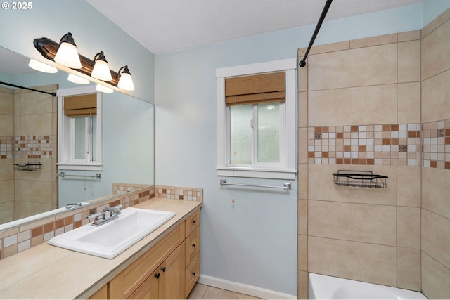 3925 SW Multnomah Blvd Unit 204, Portland, OR 97219 - bathroom featuring vanity, backsplash,  shower combination, baseboards, and tile patterned floors