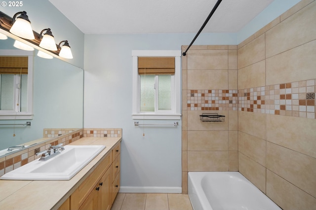 3925 SW Multnomah Blvd Unit 204, Portland, OR 97219 - bathroom featuring vanity, tile patterned flooring, bathtub / shower combination, baseboards, and backsplash