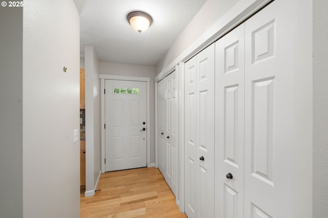 3925 SW Multnomah Blvd Unit 204, Portland, OR 97219 - entryway featuring light wood-style flooring and baseboards
