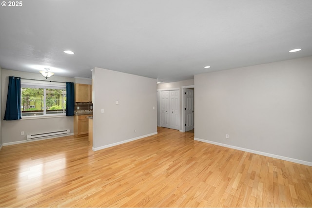 3925 SW Multnomah Blvd Unit 204, Portland, OR 97219 - empty room with baseboard heating, light wood finished floors, baseboards, and recessed lighting