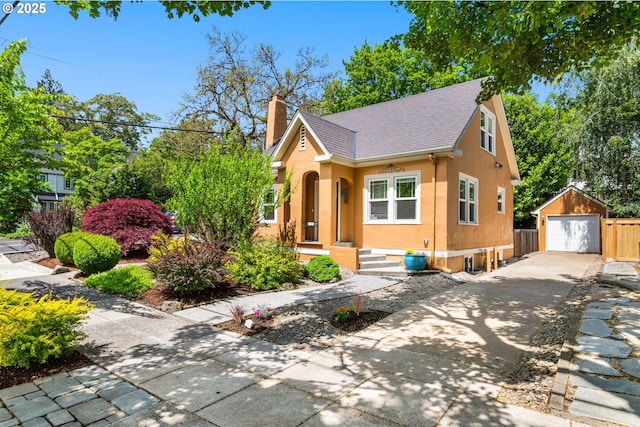 3305 NE Siskiyou St, Portland, OR 97212 - view of front facade featuring driveway, an outdoor structure, a chimney, a garage, and roof with shingles