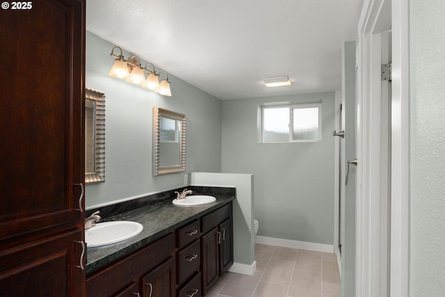 3305 NE Siskiyou St, Portland, OR 97212 - full bathroom featuring double vanity, toilet, tile patterned floors, and baseboards