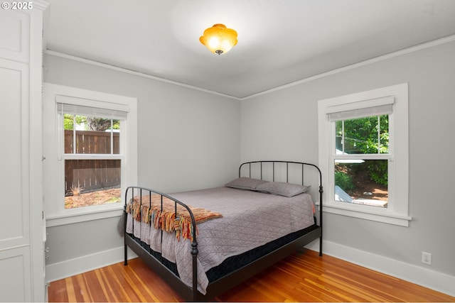 3305 NE Siskiyou St, Portland, OR 97212 - bedroom with ornamental molding, multiple windows, light wood-style floors, and baseboards
