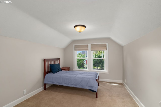 3305 NE Siskiyou St, Portland, OR 97212 - bedroom featuring light colored carpet, lofted ceiling, and baseboards