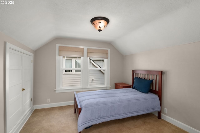 3305 NE Siskiyou St, Portland, OR 97212 - bedroom with carpet flooring, lofted ceiling, baseboards, and a textured ceiling