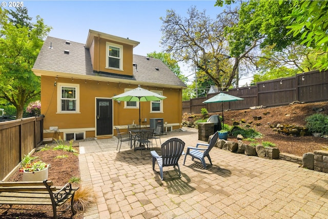 3305 NE Siskiyou St, Portland, OR 97212 - fenced backyard with a patio and cooling unit
