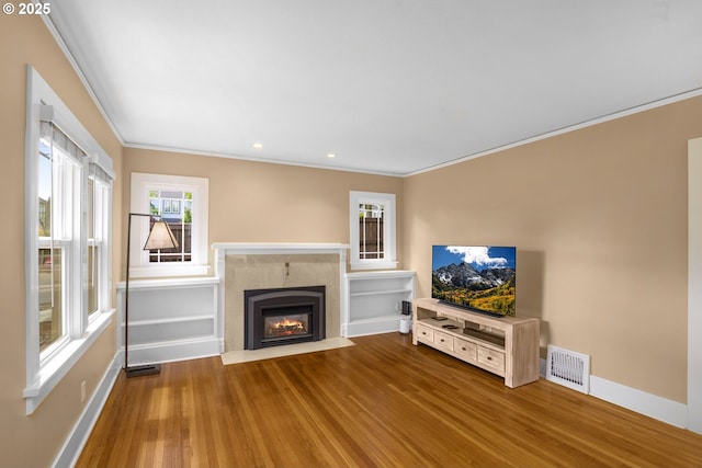 3305 NE Siskiyou St, Portland, OR 97212 - unfurnished living room with ornamental molding, wood finished floors, baseboards, a fireplace with flush hearth, and recessed lighting