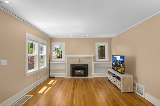 3305 NE Siskiyou St, Portland, OR 97212 - unfurnished living room featuring crown molding, wood finished floors, healthy amount of natural light, baseboards, and recessed lighting