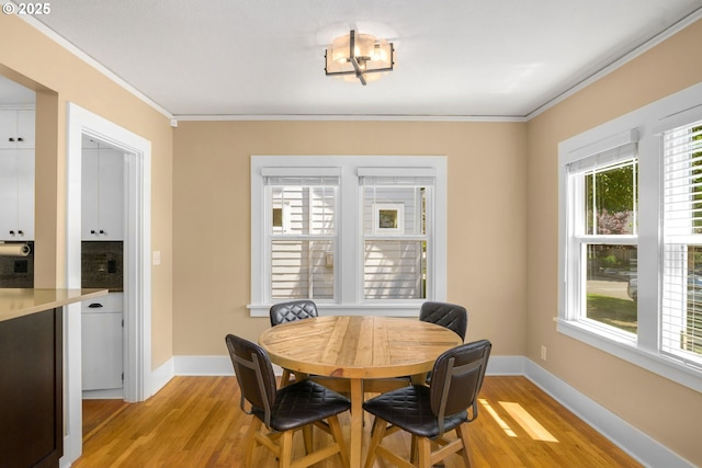3305 NE Siskiyou St, Portland, OR 97212 - dining area with light wood-style flooring, ornamental molding, plenty of natural light, and baseboards