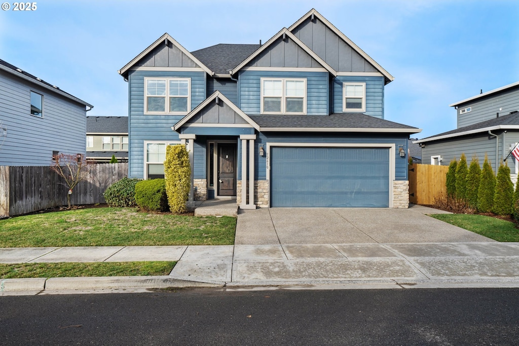 craftsman-style house with a front lawn and a garage