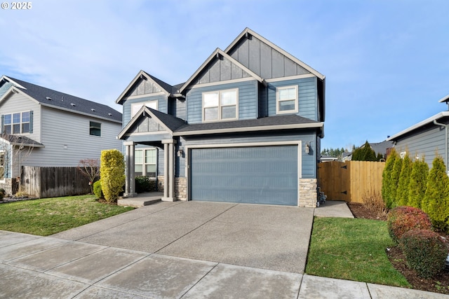 craftsman house with a front yard and a garage