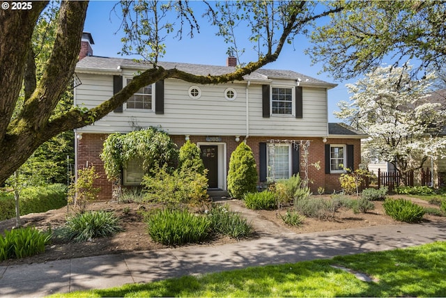 205 NE Billingher Dr, Portland, OR 97220 - colonial house featuring fence, brick siding, and a chimney