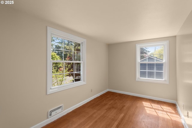 205 NE Billingher Dr, Portland, OR 97220 - empty room with plenty of natural light, baseboards, visible vents, and wood finished floors