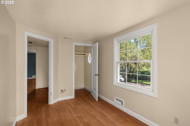 205 NE Billingher Dr, Portland, OR 97220 - unfurnished bedroom with baseboards, a closet, visible vents, and wood finished floors