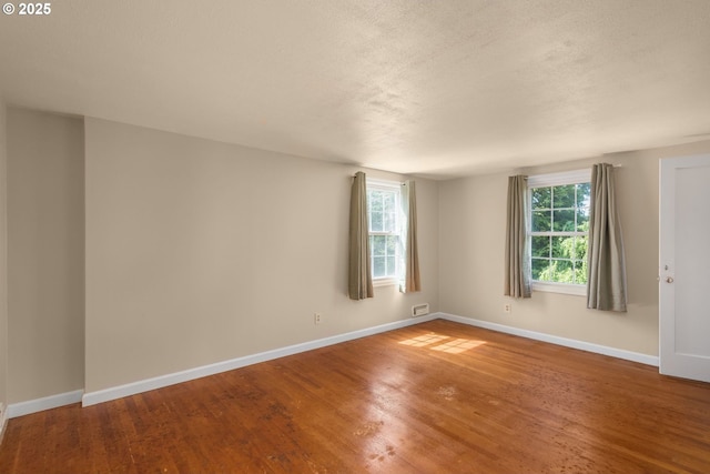 205 NE Billingher Dr, Portland, OR 97220 - unfurnished room featuring a textured ceiling, baseboards, and wood finished floors