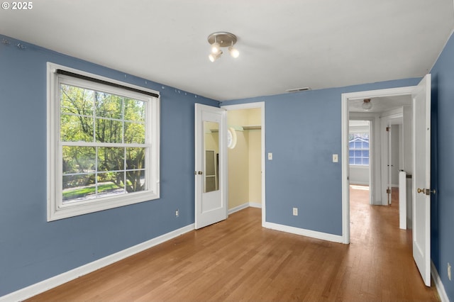 205 NE Billingher Dr, Portland, OR 97220 - unfurnished bedroom with baseboards, visible vents, and wood finished floors
