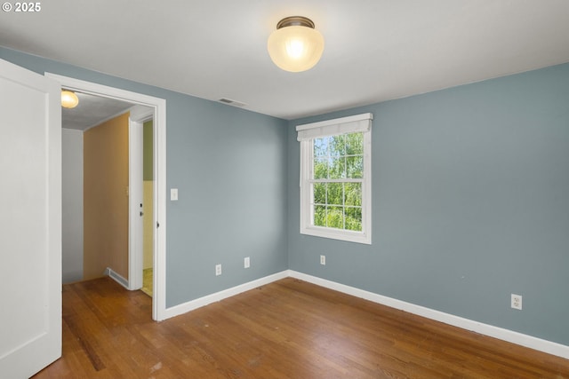 205 NE Billingher Dr, Portland, OR 97220 - spare room featuring visible vents, wood finished floors, and baseboards