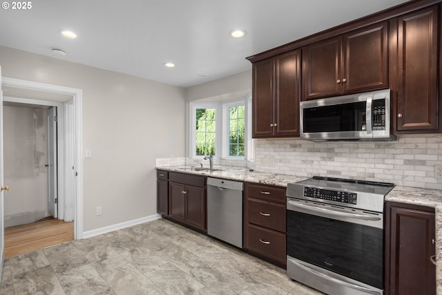 205 NE Billingher Dr, Portland, OR 97220 - kitchen with backsplash, a sink, appliances with stainless steel finishes, and dark brown cabinets