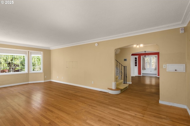 205 NE Billingher Dr, Portland, OR 97220 - unfurnished room featuring arched walkways, baseboards, light wood finished floors, and visible vents