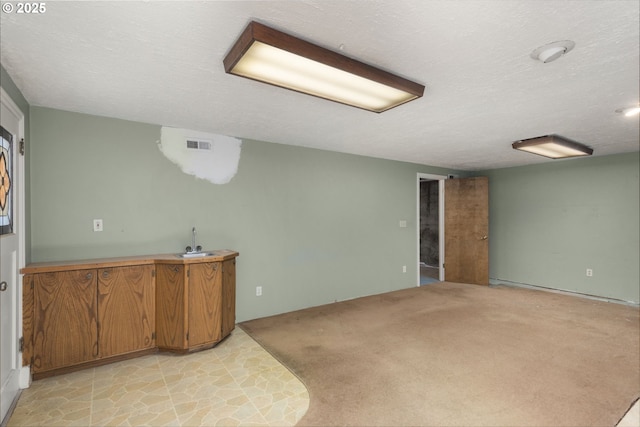 205 NE Billingher Dr, Portland, OR 97220 - finished below grade area featuring a textured ceiling, visible vents, and a sink