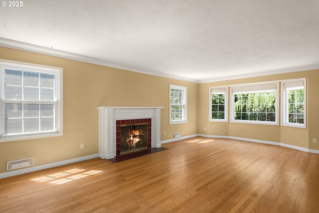 205 NE Billingher Dr, Portland, OR 97220 - unfurnished living room with light wood finished floors, a tiled fireplace, and baseboards