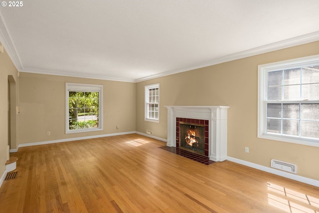 205 NE Billingher Dr, Portland, OR 97220 - unfurnished living room featuring a fireplace, crown molding, visible vents, baseboards, and light wood-style floors