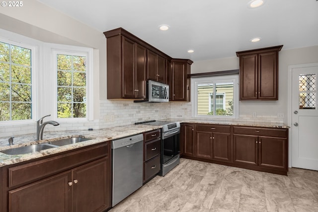 205 NE Billingher Dr, Portland, OR 97220 - kitchen with appliances with stainless steel finishes, plenty of natural light, tasteful backsplash, and a sink