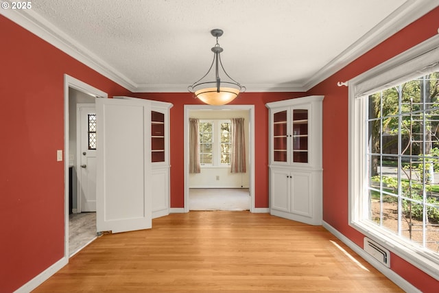 205 NE Billingher Dr, Portland, OR 97220 - unfurnished dining area featuring baseboards, light wood-style floors, a healthy amount of sunlight, and visible vents